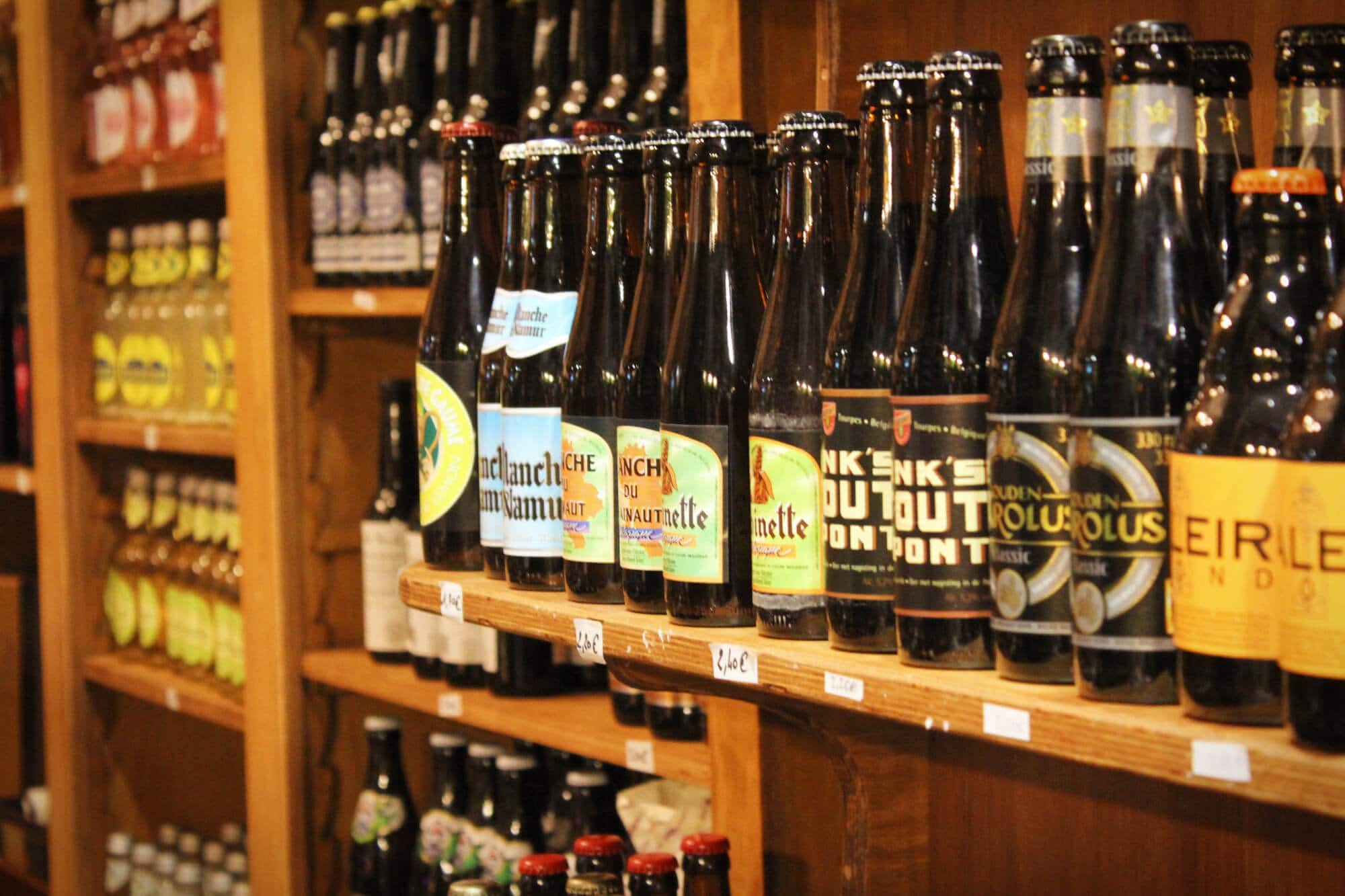 Belgian beers lined up in a Belgian Beer Store. Belgian beer stores are a bit like like beer libraries.