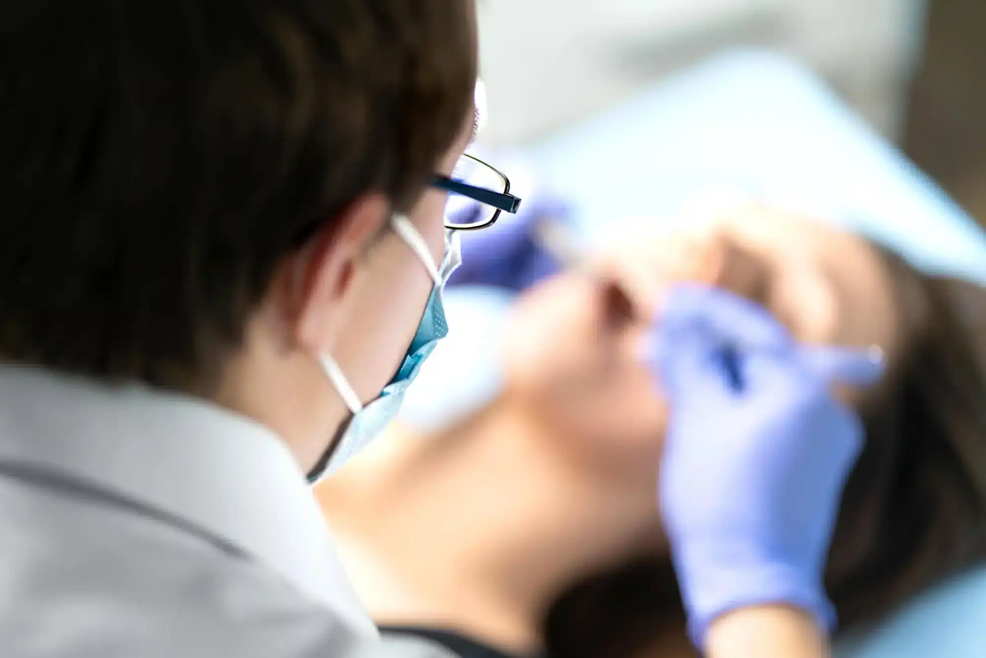 Dentist performing surgical wisdom teeth removal in Riverview, MI for impacted molars.