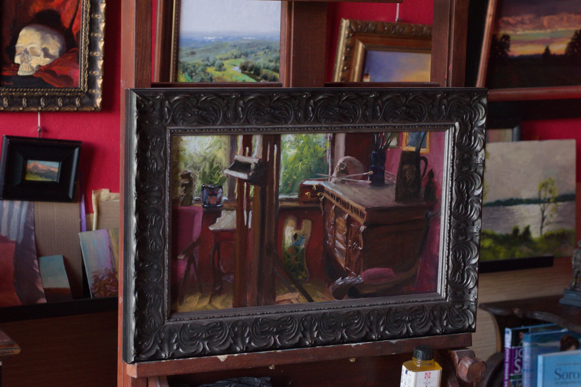 Original oil painting of an artist studio interior with wooden furniture, easel, palette, brushes and natural light from the window