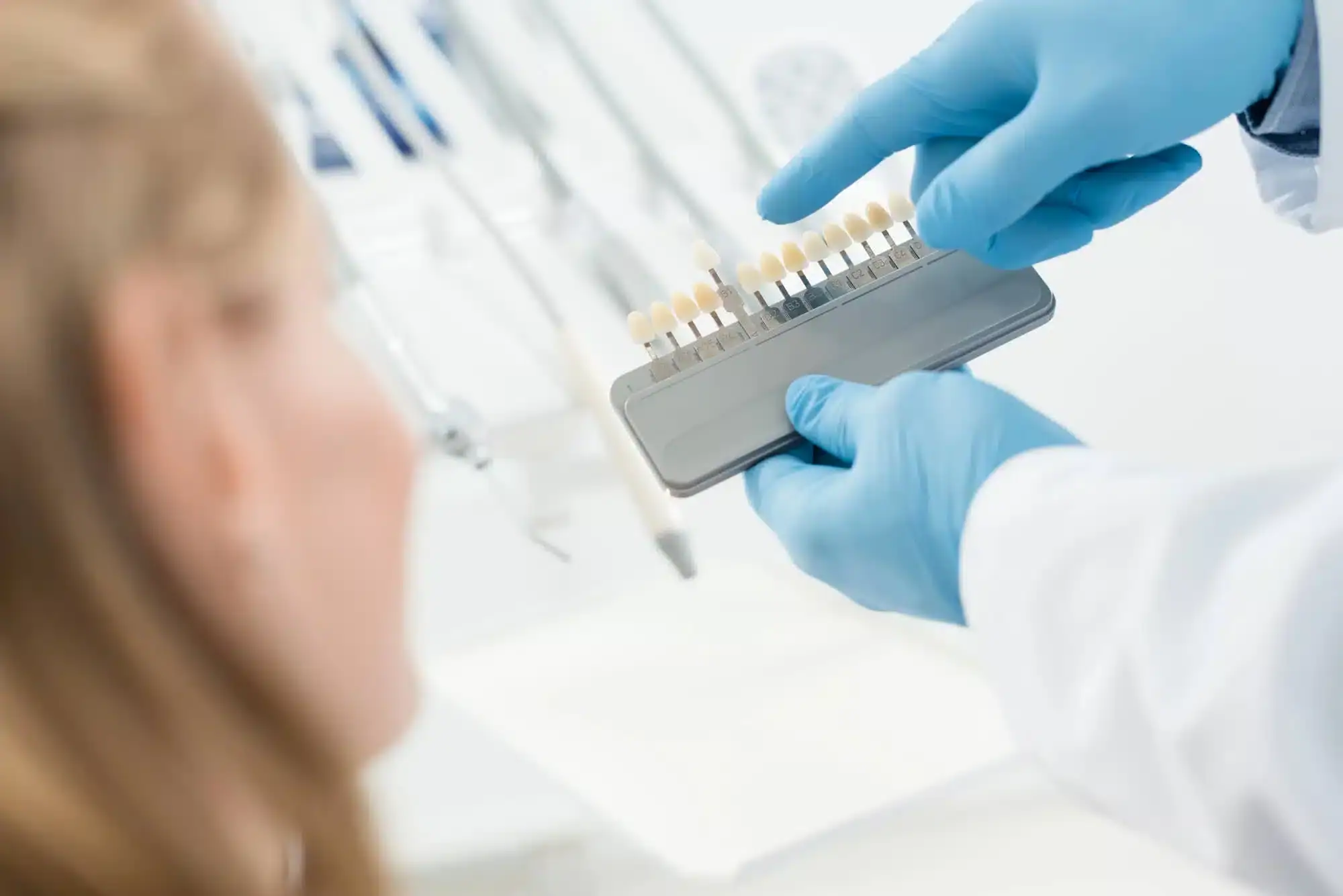 Dentist-and-female-patient-choosing-the-color-of-dental-implants-in-Riverview-MI.