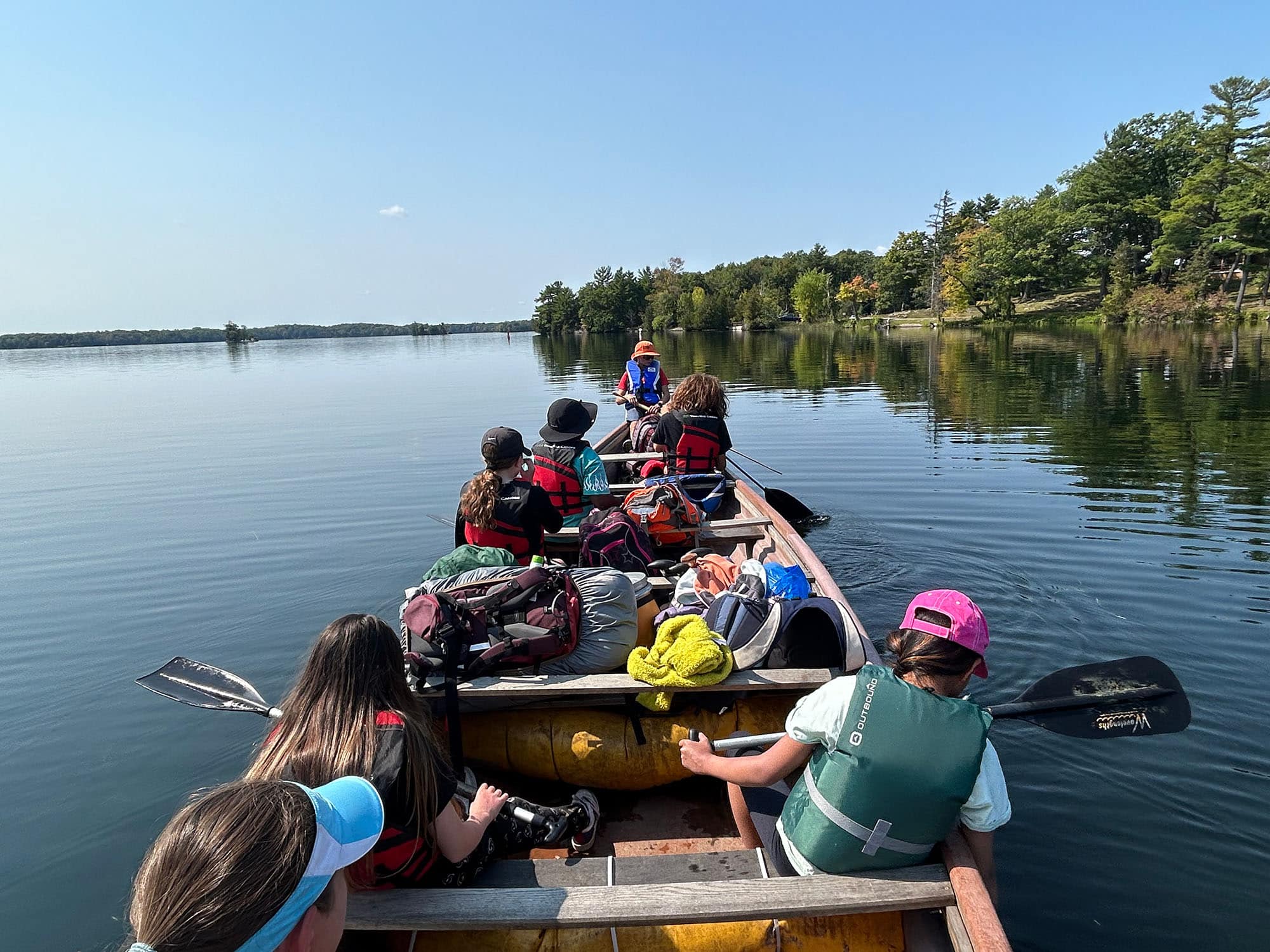 A group of students on a canoe rowing out on a lake | Bishop Hamilton Montessori School in Ottawa