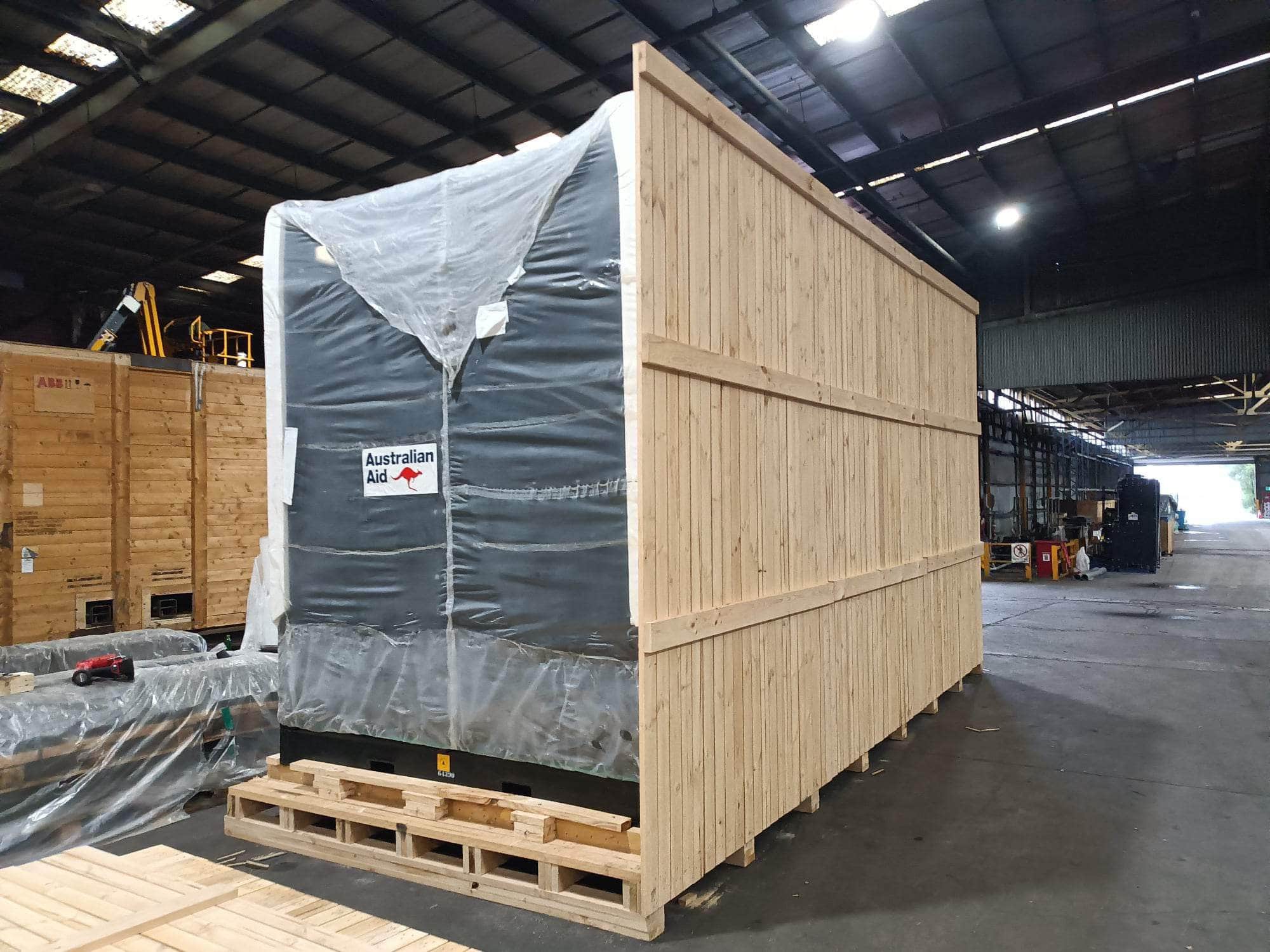 wooden shipping crate with cumins machine inside