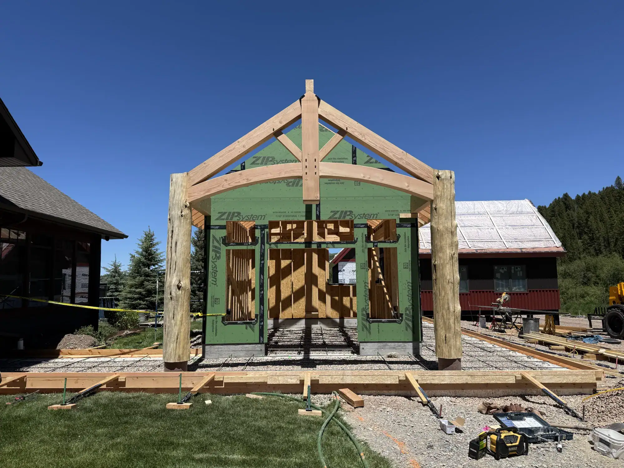 New fir king-post truss with a curved bottom chord on round log posts