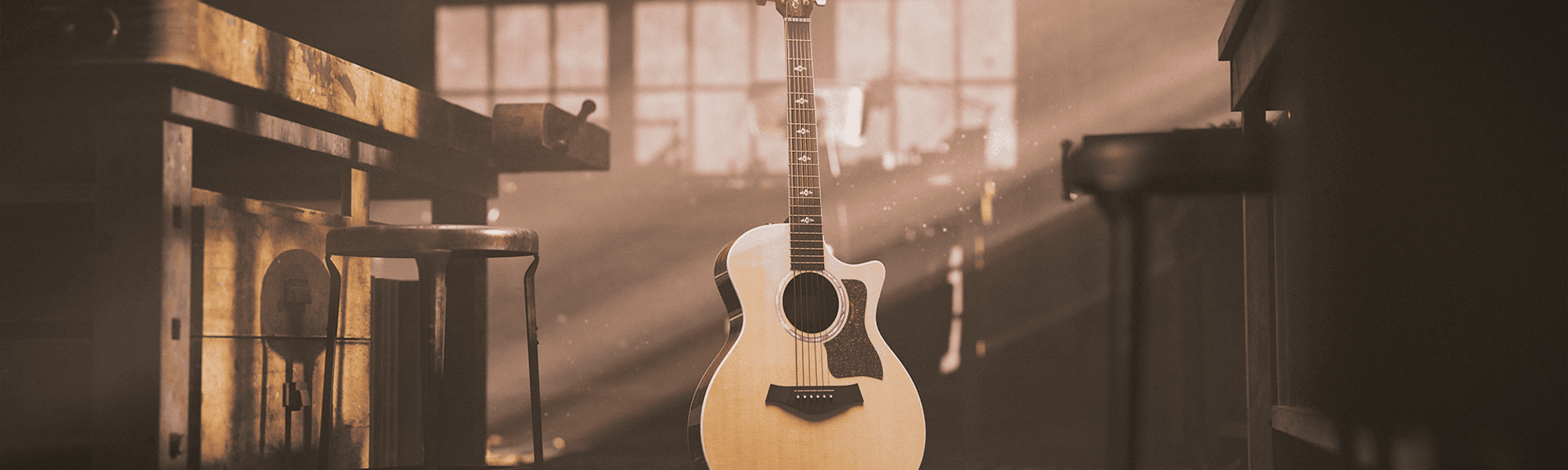 Taylor 814ce Guitar in a rustic workshop with dust in the air