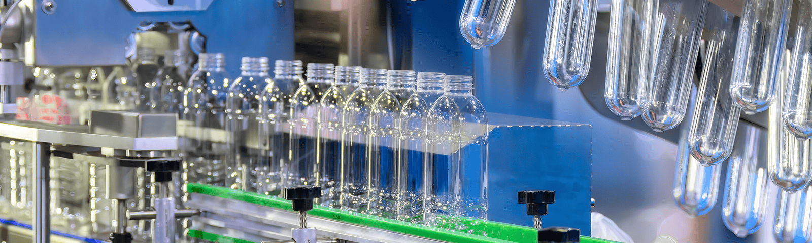 PET bottle and preform testing equipment inspecting bottles in a factory