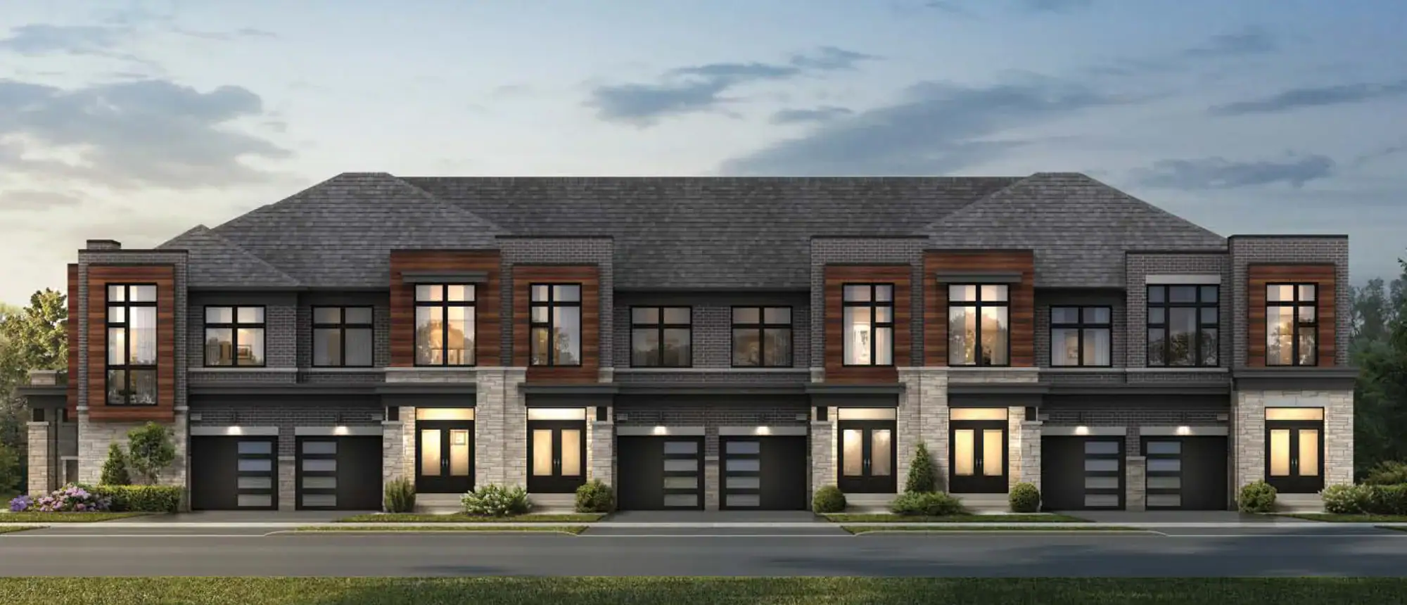 Architectural rendering of contemporary townhouses by Arista Homes in New Kleinburg, showcasing a dramatic multi-unit facade with warm wood-grain paneling accents, light stone detailing, and illuminated entryways at dusk.