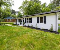 Modern suburban home with lush green lawn and landscaped garden in Cambridge, Ontario spring renovation.