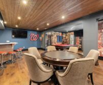 Modern basement game room with bar, seating, and pool table for spring addition contractor projects in Guelph.