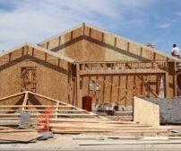 Home Addition cost in Waterloo - Framing stage of a new home under construction in Elk Grove, California.