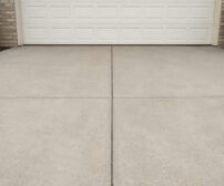 Concrete Driveway cost in Guelph - A concrete driveway in front of a white garage door