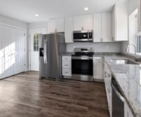 Kitchen Renovation cost in Guelph - Bright and spacious modern kitchen featuring stainless steel appliances and granite count