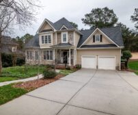 Charming suburban Guelph home with two-car garage, manicured lawn, and inviting entrance for concrete driveway budgeting