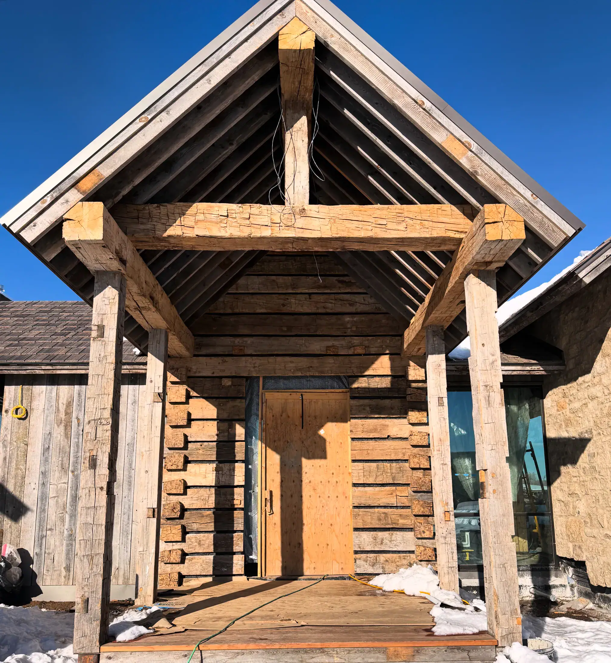 Finished entry truss on round log posts