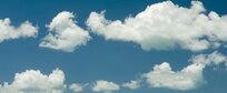 A blue sky with fluffy clouds