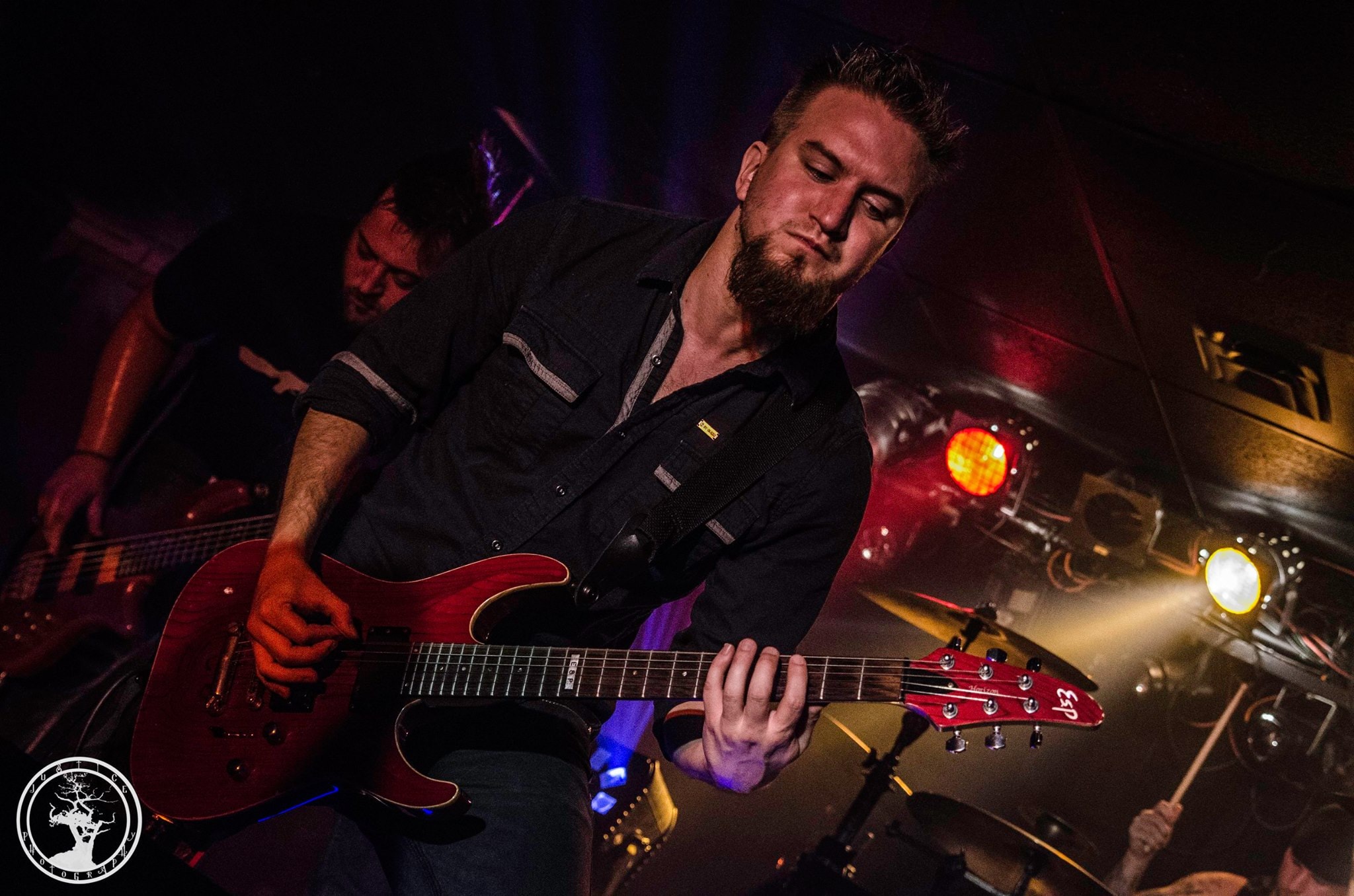 James Brennaman Performs on guitar with Pulse at Collapsefest during August 2014 in Kansas City, Kelly Robinson on bass, in background.