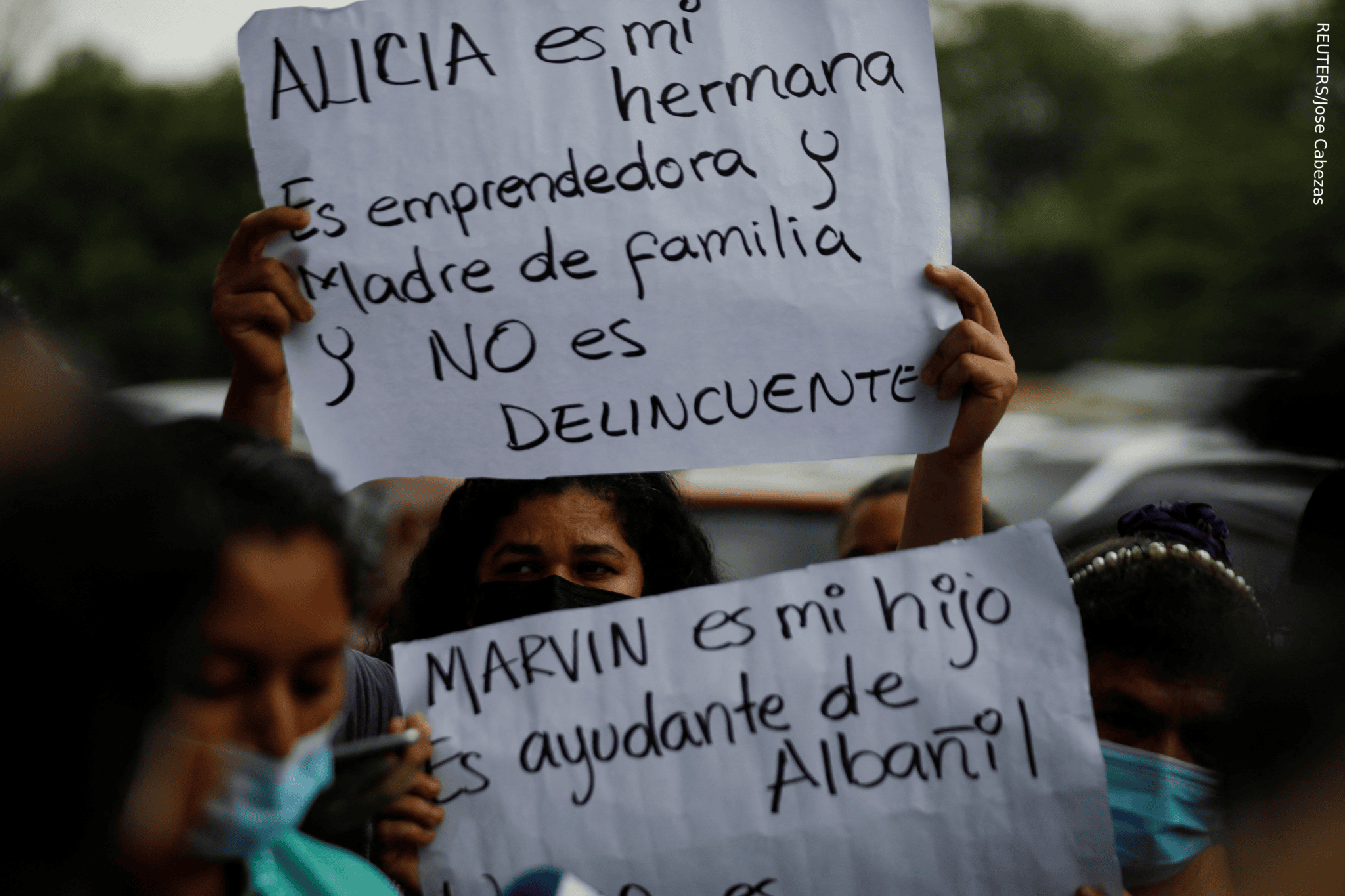 Women hold signs at protest