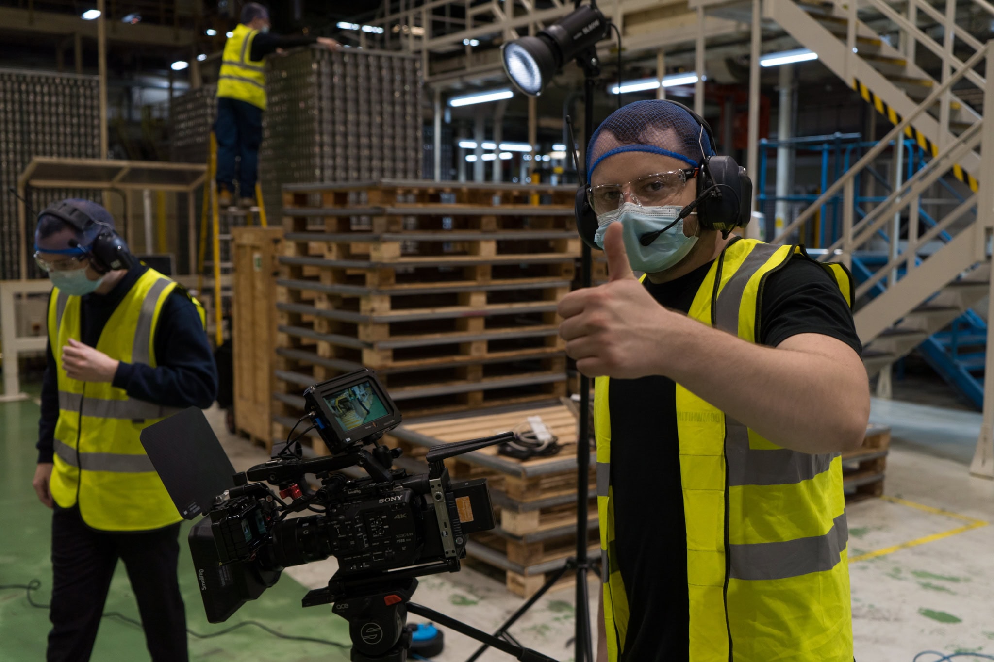Safety Video 04 A behind the scenes photo of a member of the videography team giving a thumbs up to camera