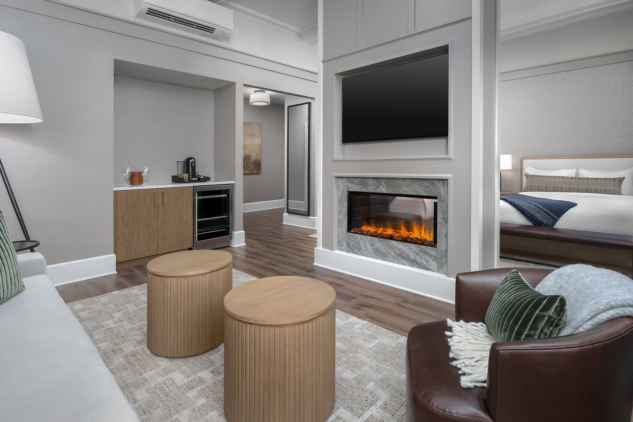Restored interior of a Legacy guest room at The Inn at Dayton with hardwood floors, fireplace, and contemporary furnishings.