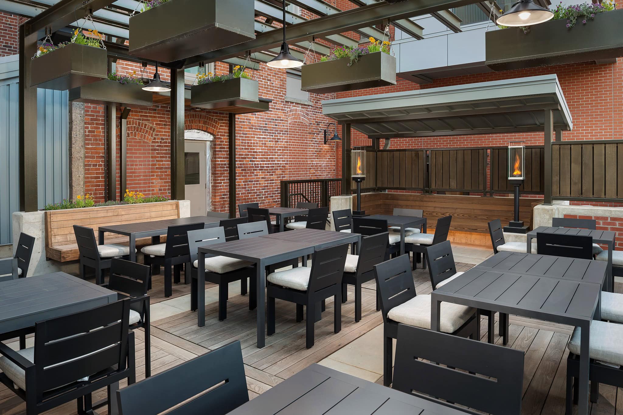 Restored brick courtyard with outdoor seating and planters at The Inn at Dayton in Oregon wine country.