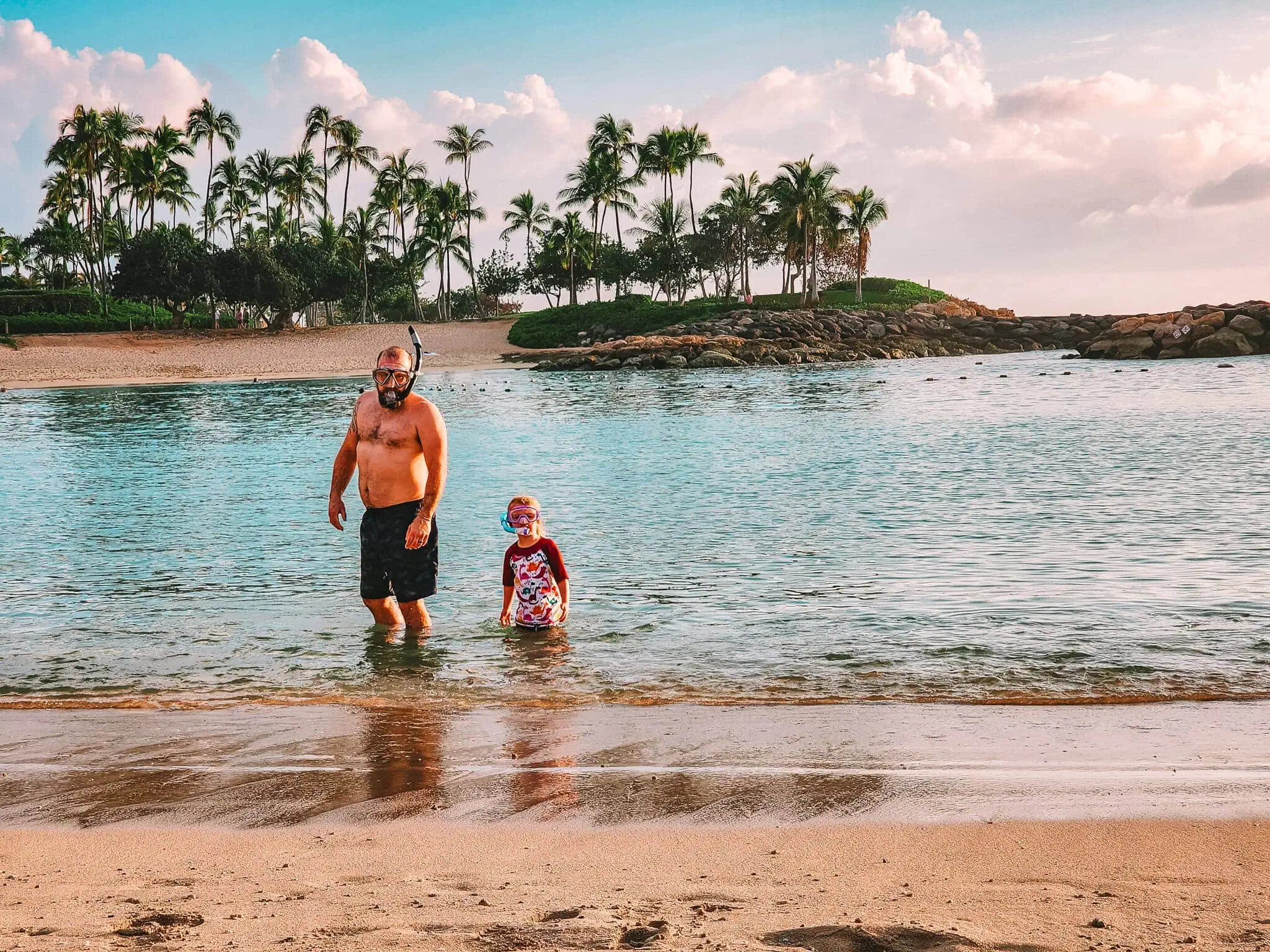 Father and daughter snorkeling in the Ko Olina Lagoon. Featured image for the post things to do in Oahu for families.