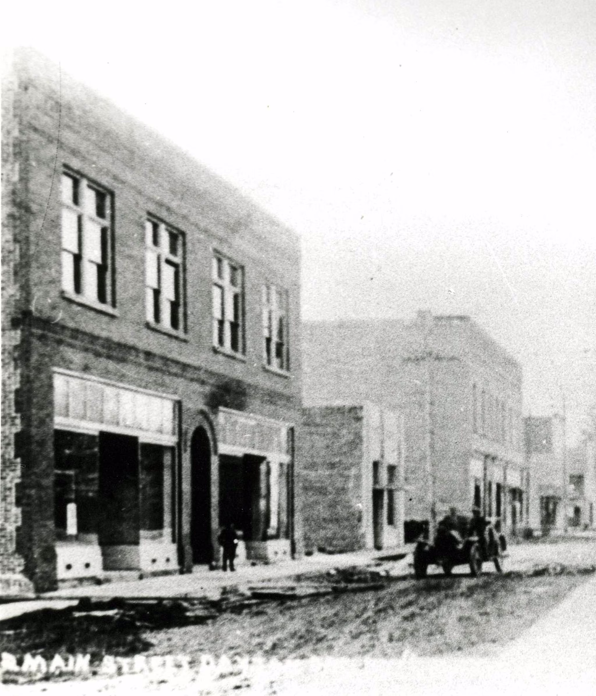 Newly built Commercial Club and S. C. Stuckey Building on unpaved Ferry Street in downtown Dayton, Oregon, in 1911.