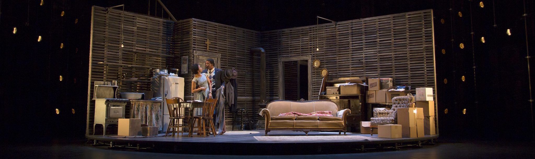 Stage scene from "A Raisin in the Sun" with actors and set design.