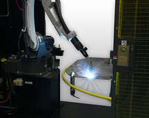 Image of robotic MIG gun welding with sparks