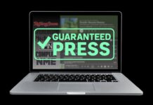 Laptop that displays "Guaranteed Press" across the screen