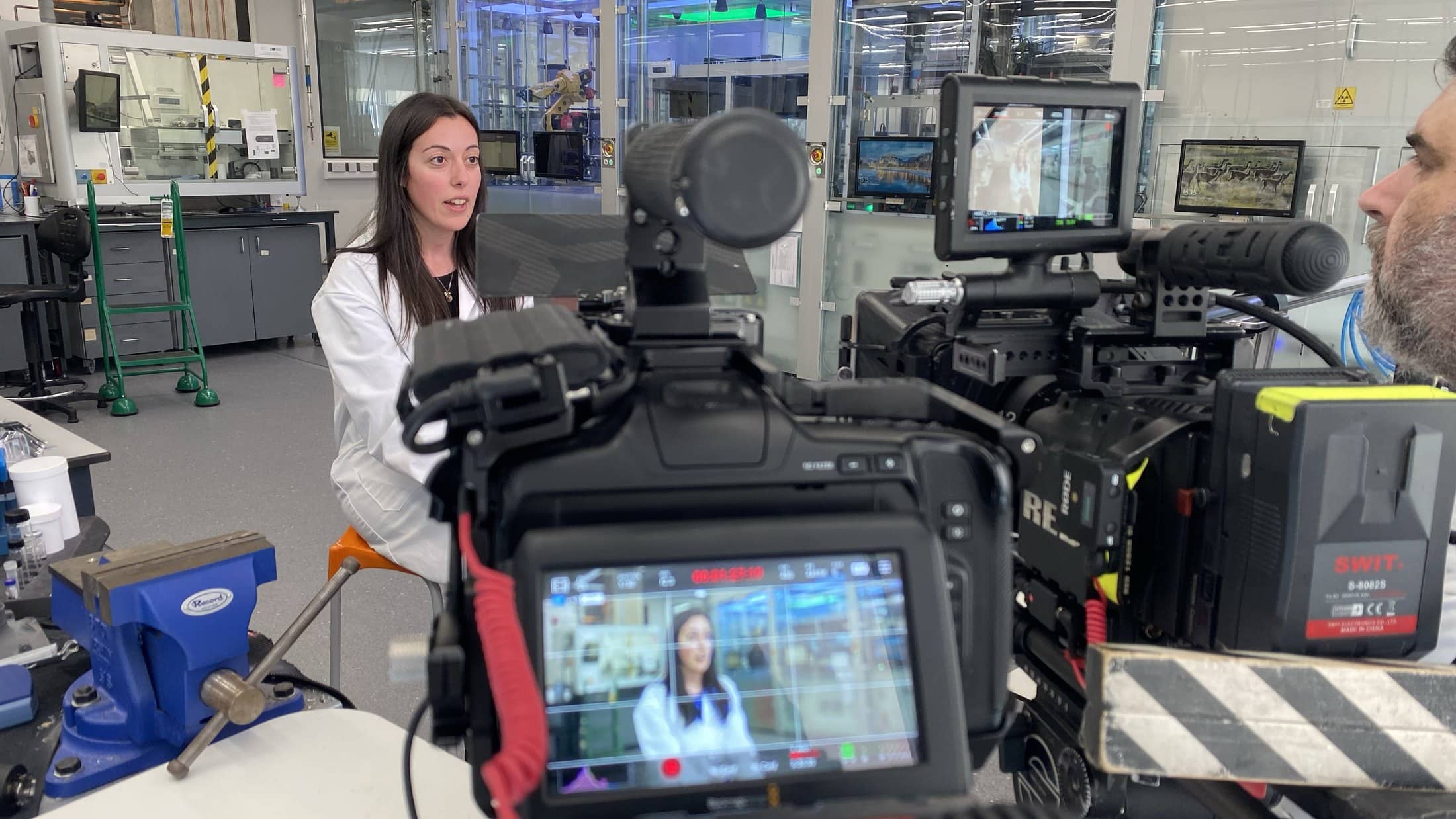 An Aposs camera and monitor set up for an interview with a technician in a laboratory