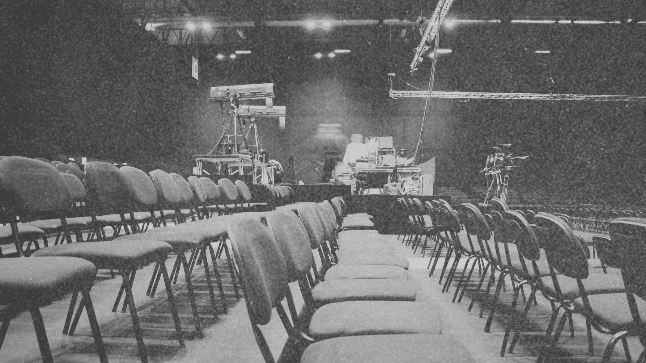 Rows of chairs neatly arranged for a conference with an AV setup in the background, showcasing seamless event management solutions for a well-organized and engaging attendee experience. Coast to Coast Conferences & Events ensures every detail is meticulously planned for maximum impact.