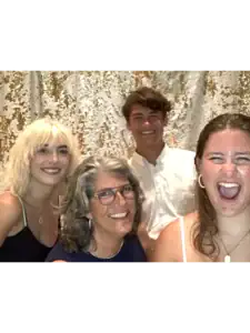 Group of guests posing with props at Fastbooth photobooth in Grand Rapids, MI during a lively indoor event.