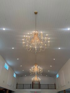 Crystal chandeliers hanging from the reception hall ceiling at Romaine Valley Weddings & Events in Fenton, MO