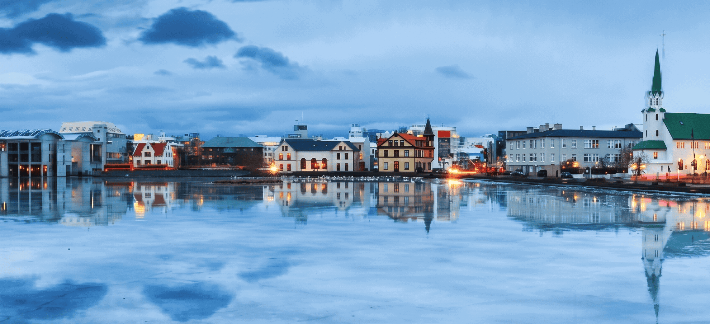 Reykjavik Iceland Tours – Colorful Buildings Reflected in Lake Tjörnin at Twilight
