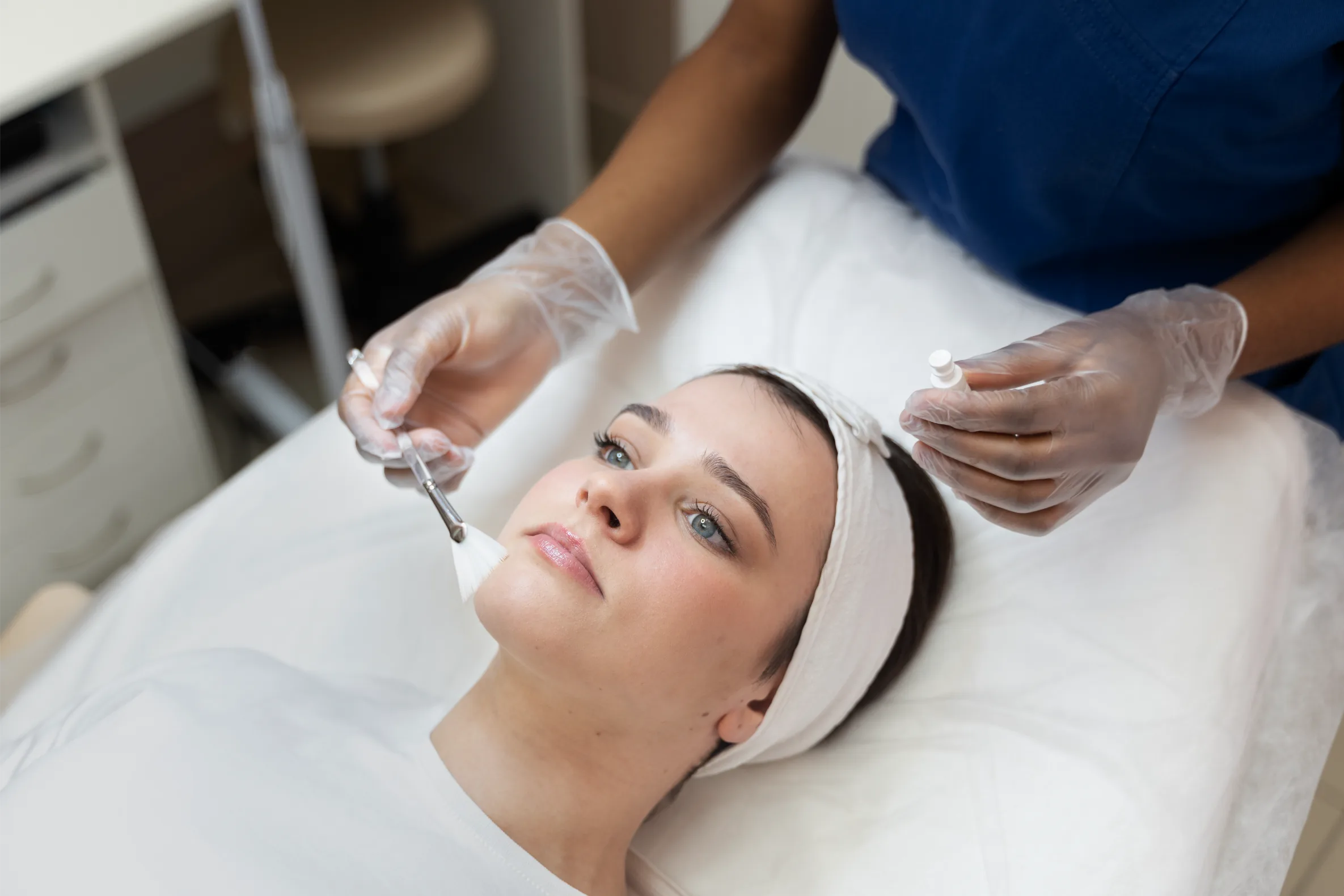 Acne treatment being applied to patients face