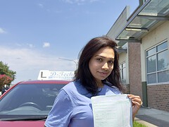 Successful D-Tech driving student celebrating passing their driving test at the registry.