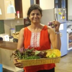 woman holding green leaves