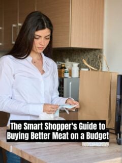 A woman in a white shirt standing in a kitchen, reviewing a receipt next to a brown paper grocery bag.