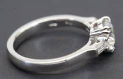 Engagement ring featuring a sparkling solitaire diamond set in a sleek silver band. Perfect for spec.