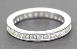 Diamond eternity ring with sparkling stones in a silver band.