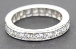 Elegant diamond eternity ring with sparkling stones in a silver band.