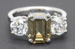 An emerald-cut diamond ring with side stones, crafted by Weldons Jewellers, Dublin.