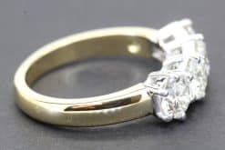 Gold and silver diamond ring with three large sparkling stones.