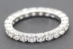 Diamond eternity ring with sparkling gemstones on a silver band.