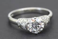 Diamond heart-shaped engagement ring with side stones, crafted in silver.