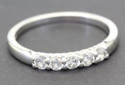 Diamond eternity ring with multiple sparkling stones in silver band.