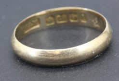 Vintage gold ring with hallmark stamps for authenticity and quality.