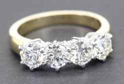 Diamond eternity ring with multiple sparkling stones on a gold band.