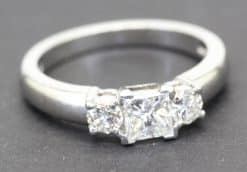 Stunning diamond engagement ring with three sparkling stones in a silver band.