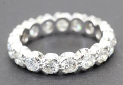 Diamond eternity ring with sparkling round-cut stones in a silver setting.