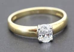 Gold engagement ring with a sparkling cushion-cut diamond.